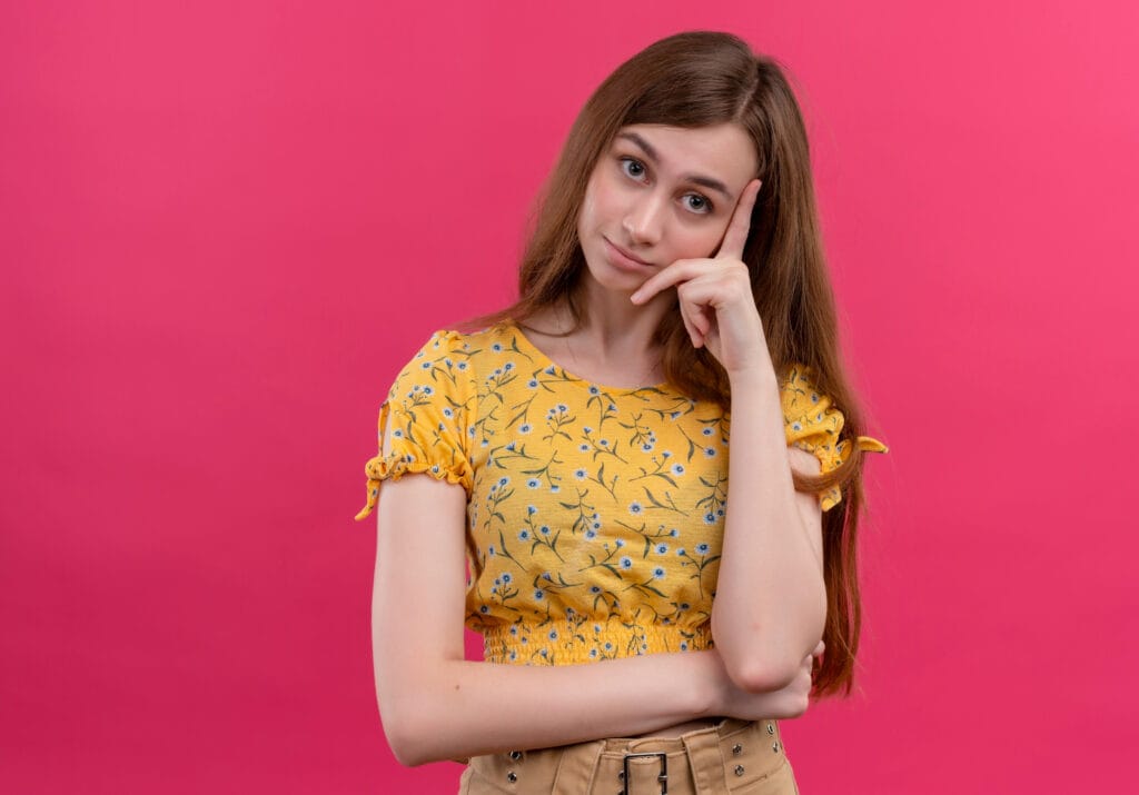 A thoughtful young woman considering her health insurance options.