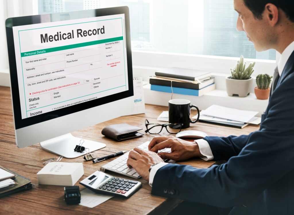 Healthcare professional reviewing medical billing and reimbursement forms for health insurance claims.
