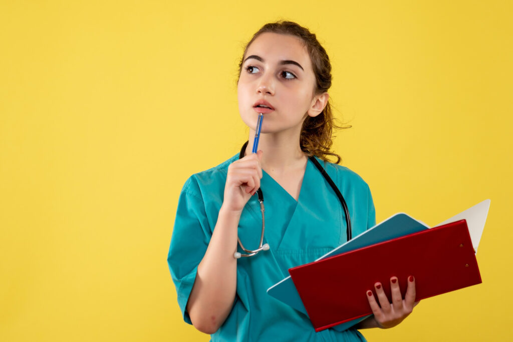A female doctor thoughtfully considering how private health insurance works.