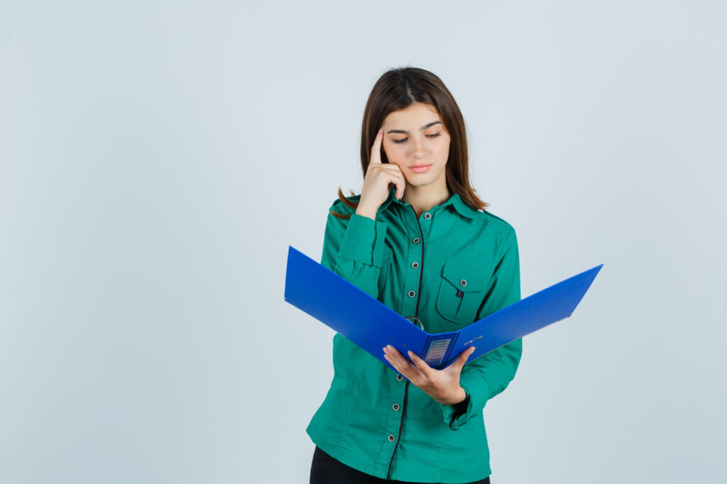 A cute woman thinking about how insurance works.